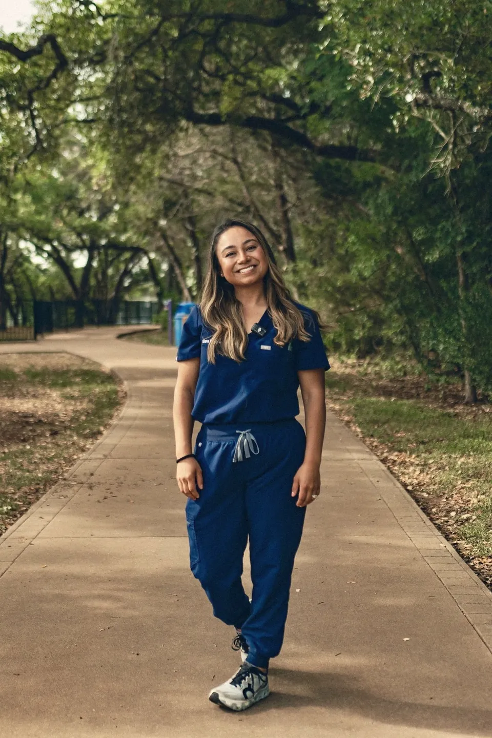 Liliana Damron outdoors in navy scrubs.